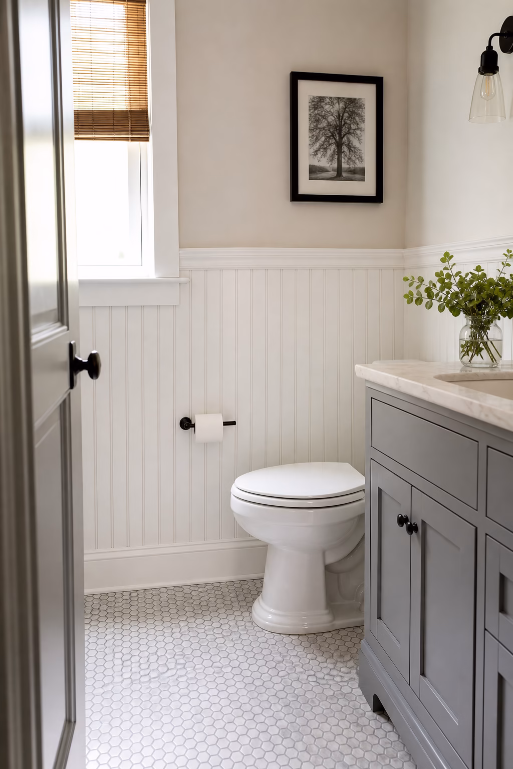 Remodeled bathroom detail with coordinated hardware, folded towels, and painted vanity