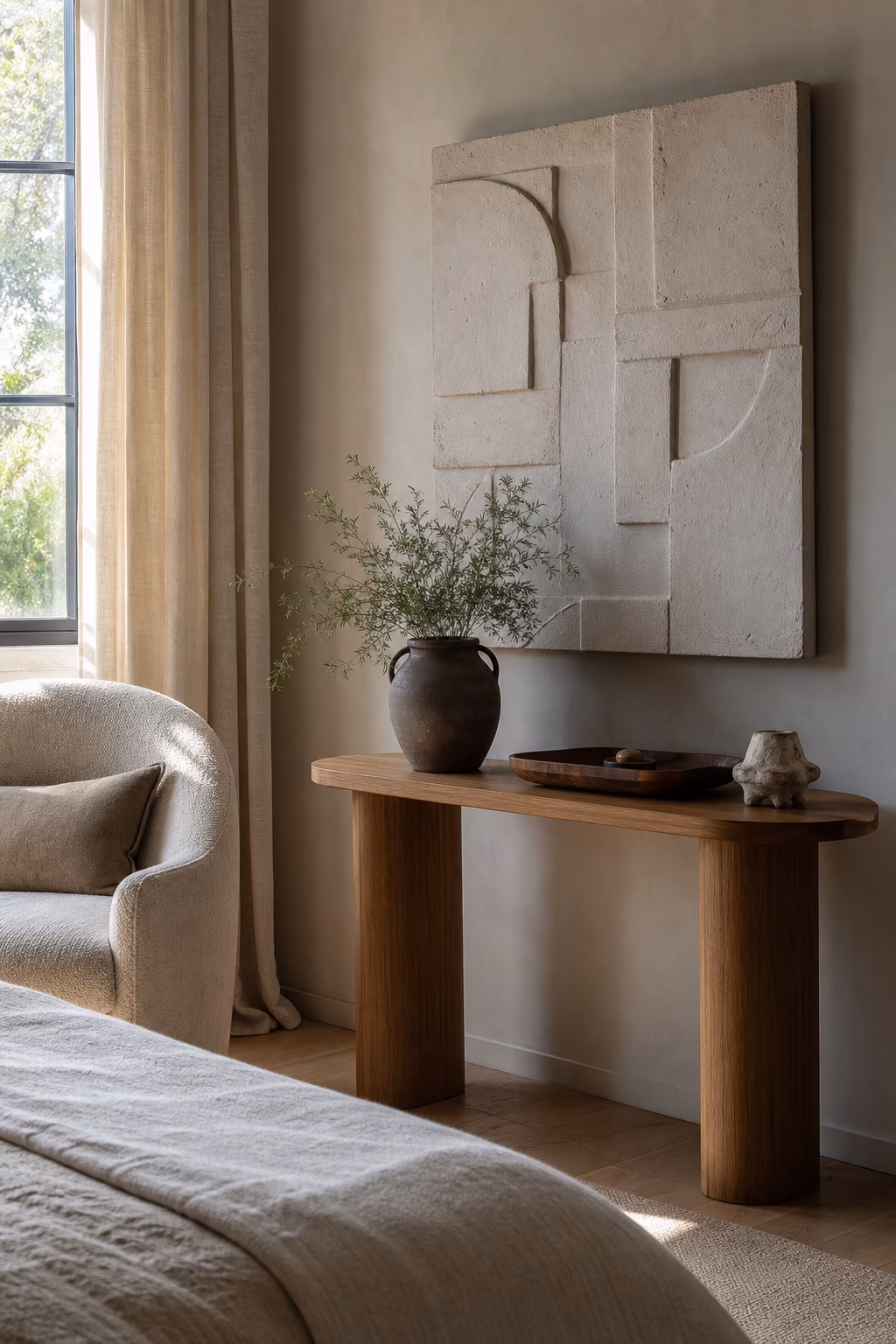 Handmade ceramic wall relief adding tactile decor to a sophisticated bedroom