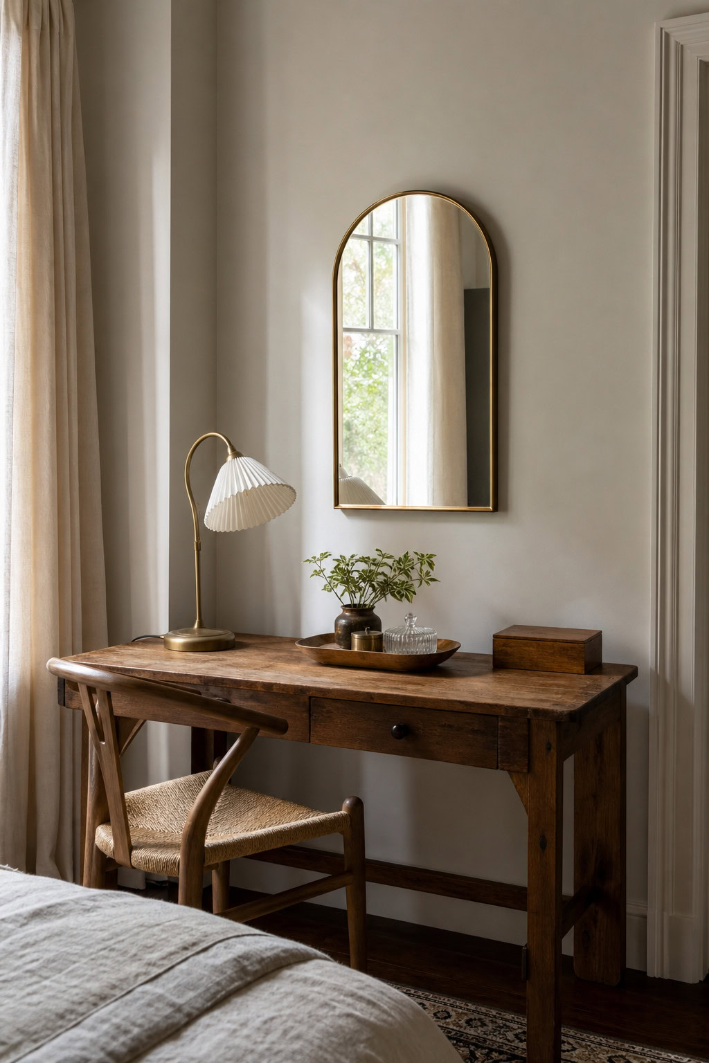 Small arched mirror brightening a compact desk nook