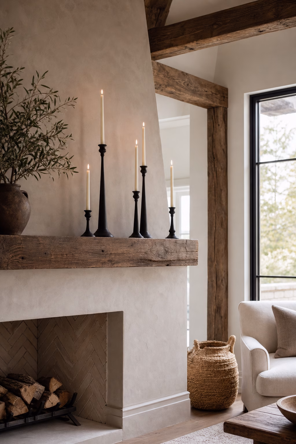 Matte black iron candlesticks adding contrast to a modern mantel