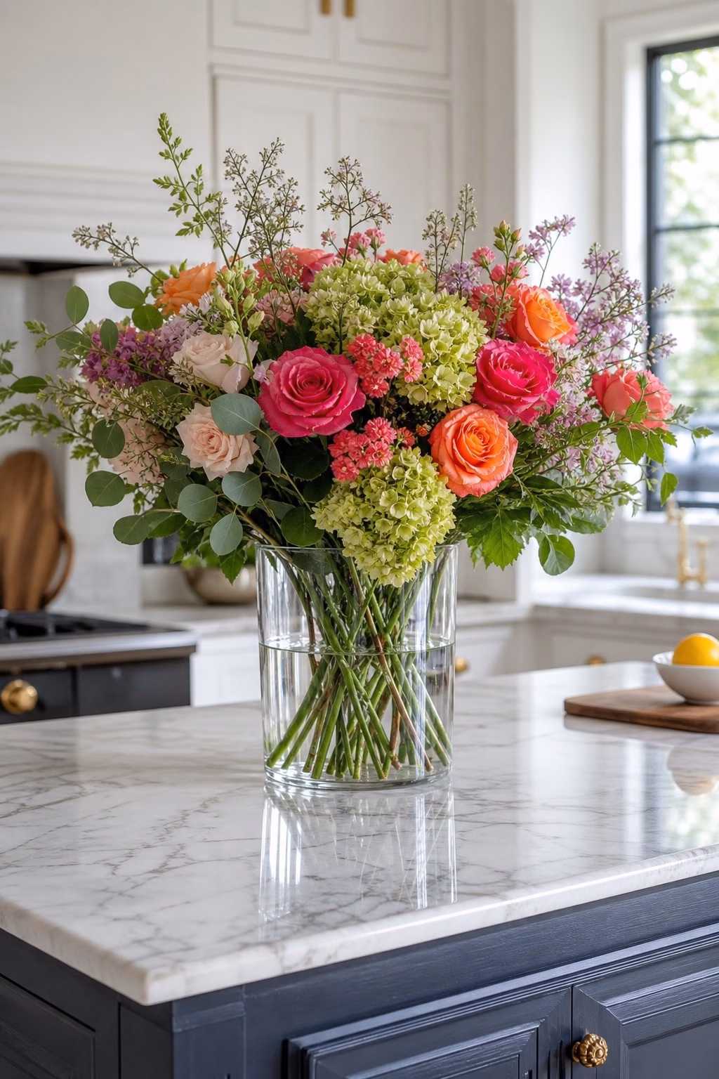 Clear glass vase showcasing colorful fresh flowers on a kitchen island
