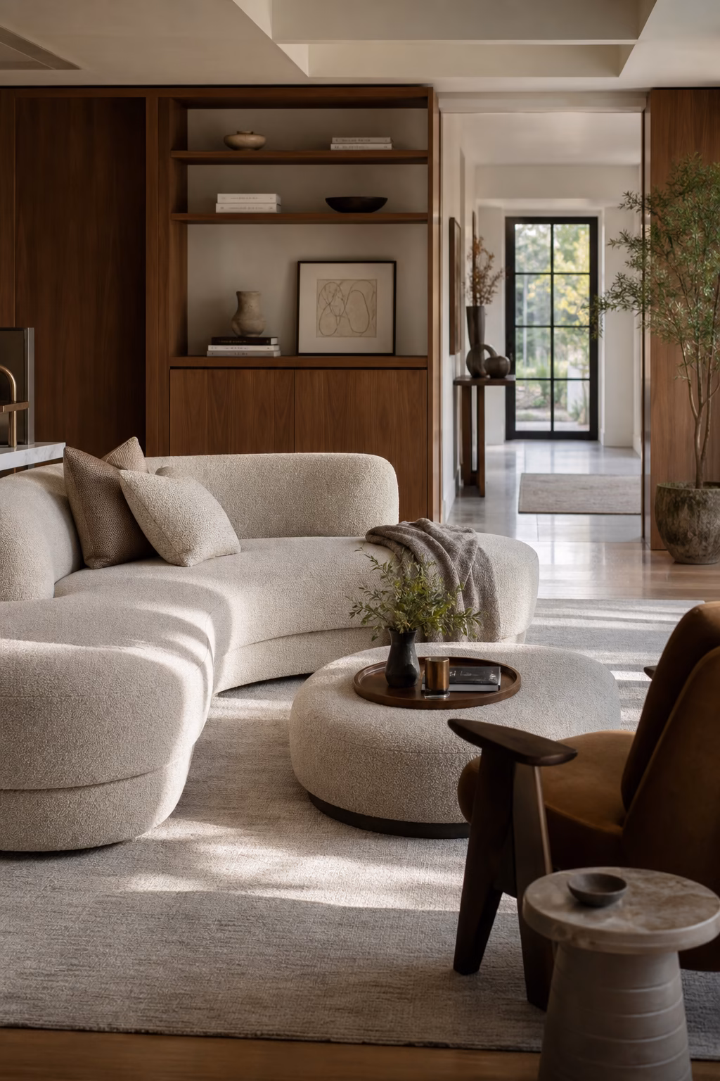 Curved modern furniture arranged to guide movement through a living room