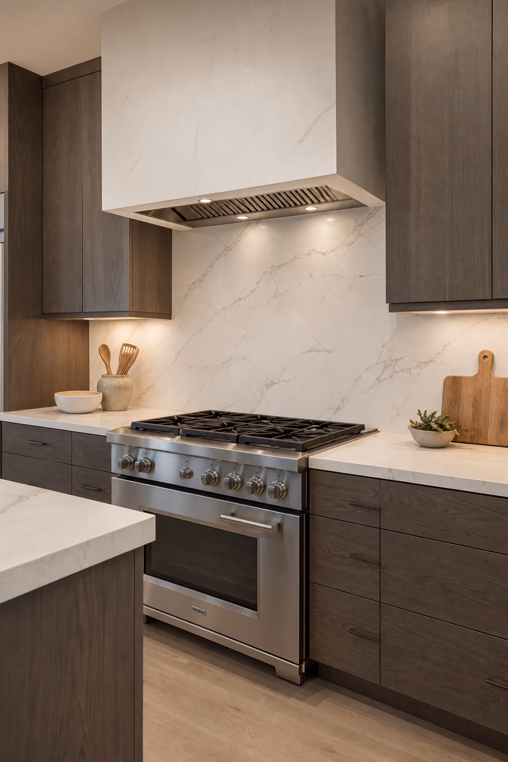 Kitchen remodel with a continuous slab backsplash, quiet veining, and seamless counter detail.