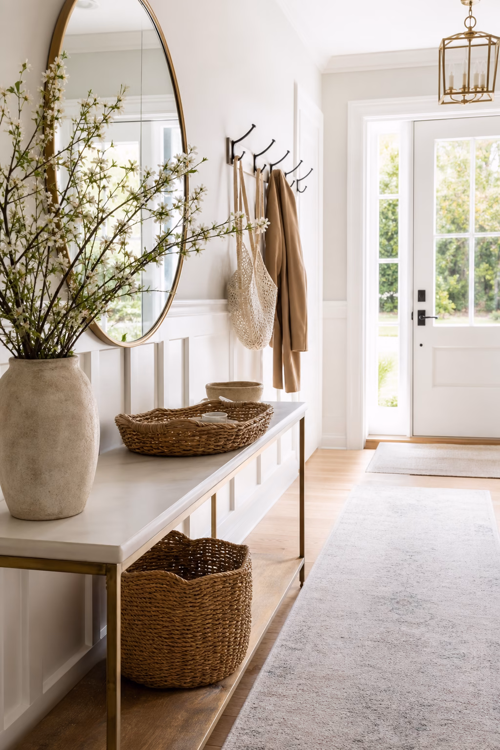 Washed bright spring entry with mirror runner and fresh branches