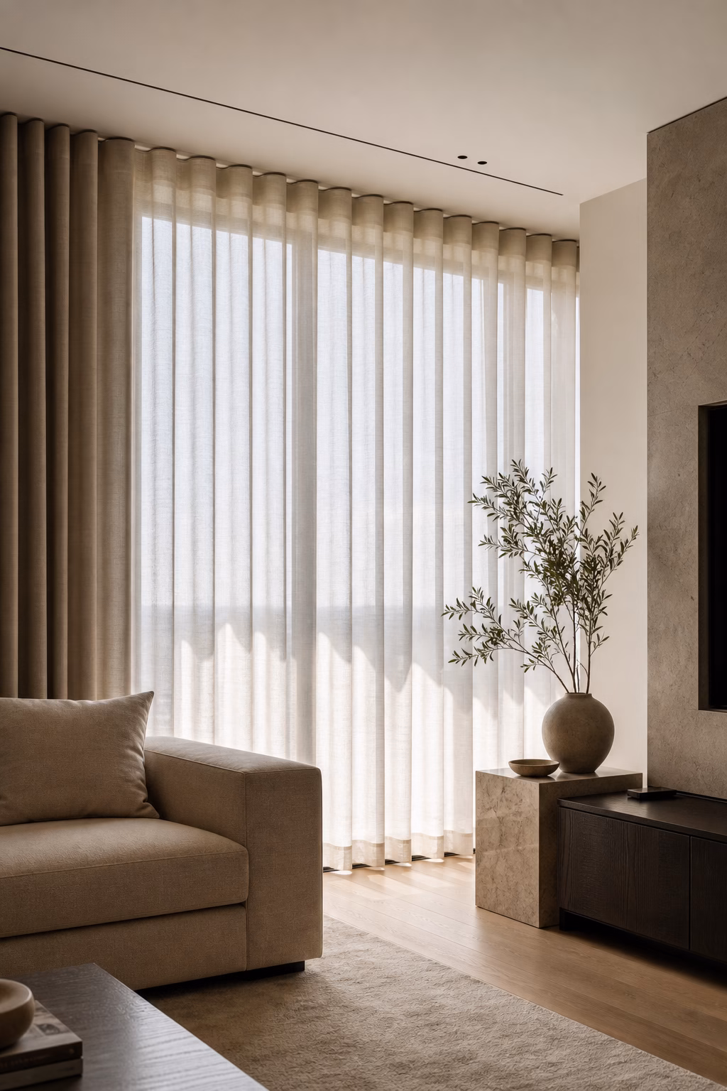 Modern living room with ripple fold curtains on a discreet ceiling track