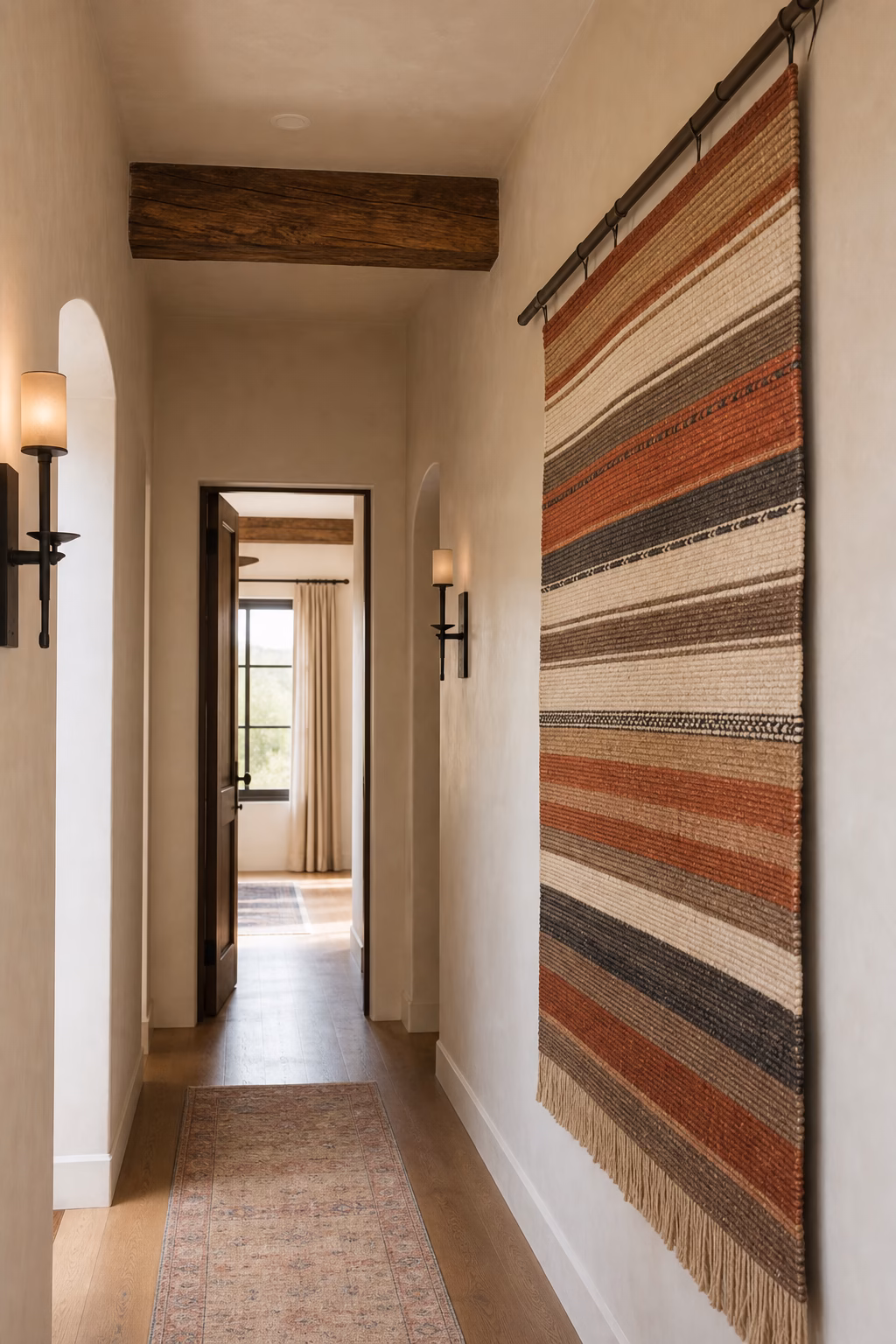 Earth-toned striped wall hanging adding warmth to a narrow hallway.