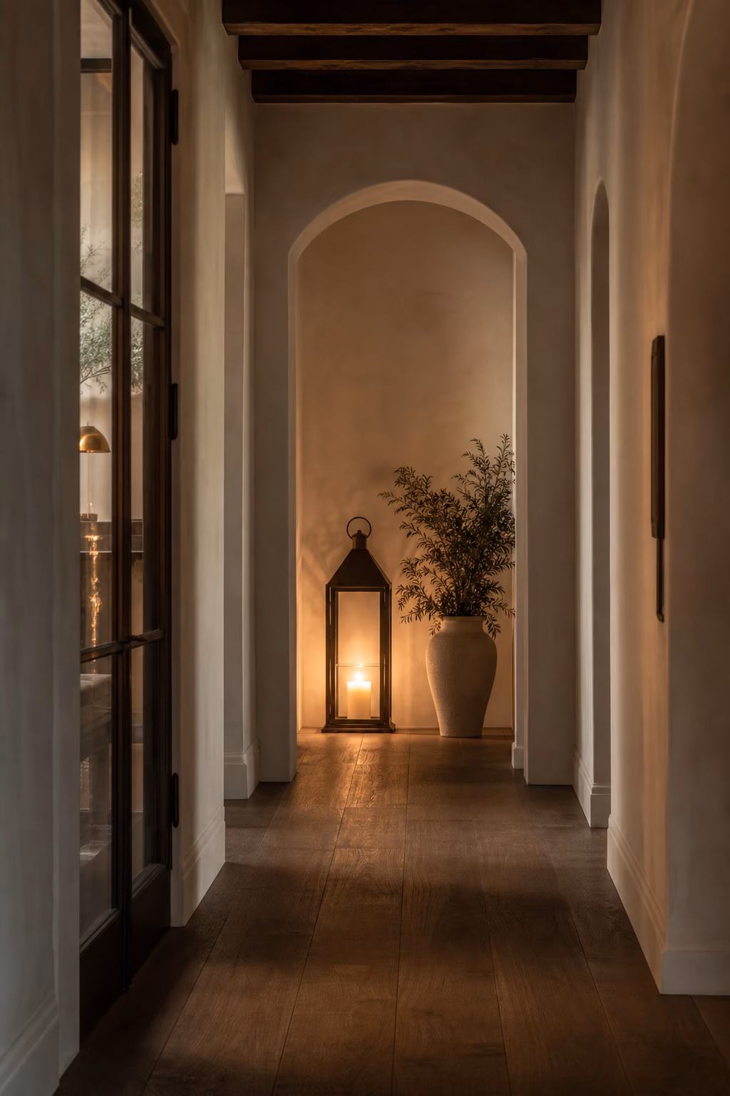 Large candle lantern placed at the end of a refined hallway sightline
