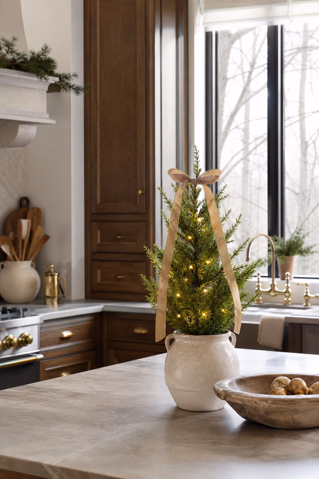 Mini Christmas tree adding festive charm to a refined kitchen counter