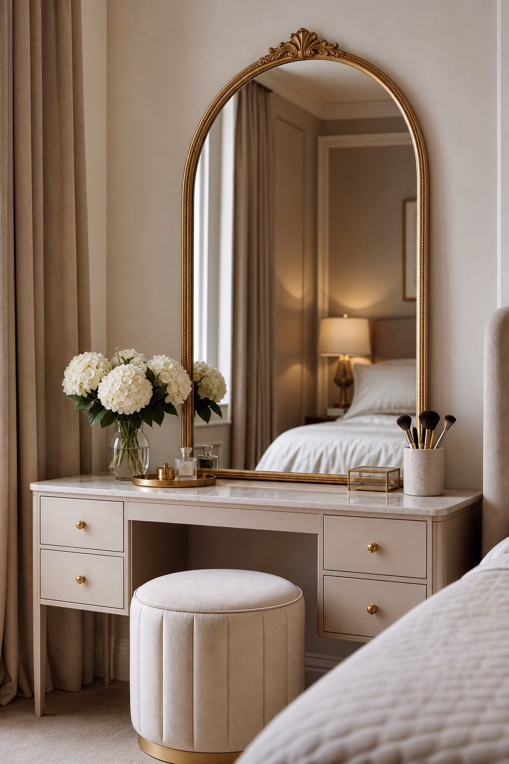 Arched gold mirror creating an elegant bedroom vanity moment