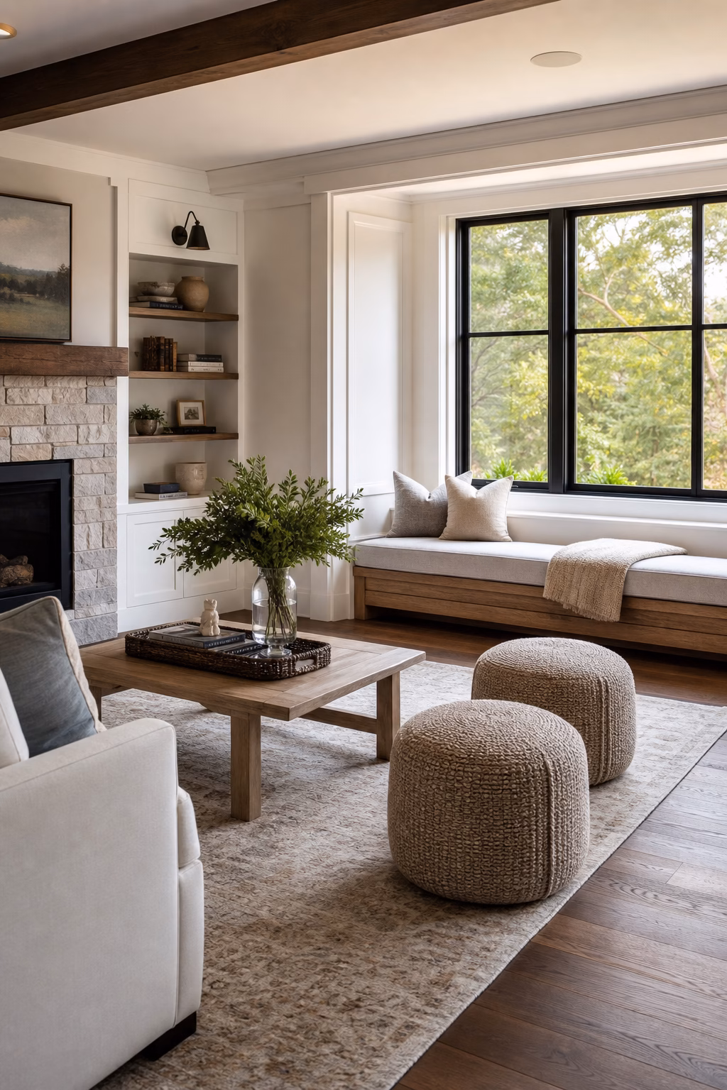 Cozy living room with a low bench and poufs providing flexible extra seating.