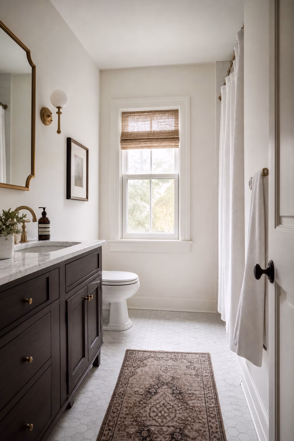 Compact bathroom with freshly painted warm white walls, crisp trim, existing tile, and updated vanity