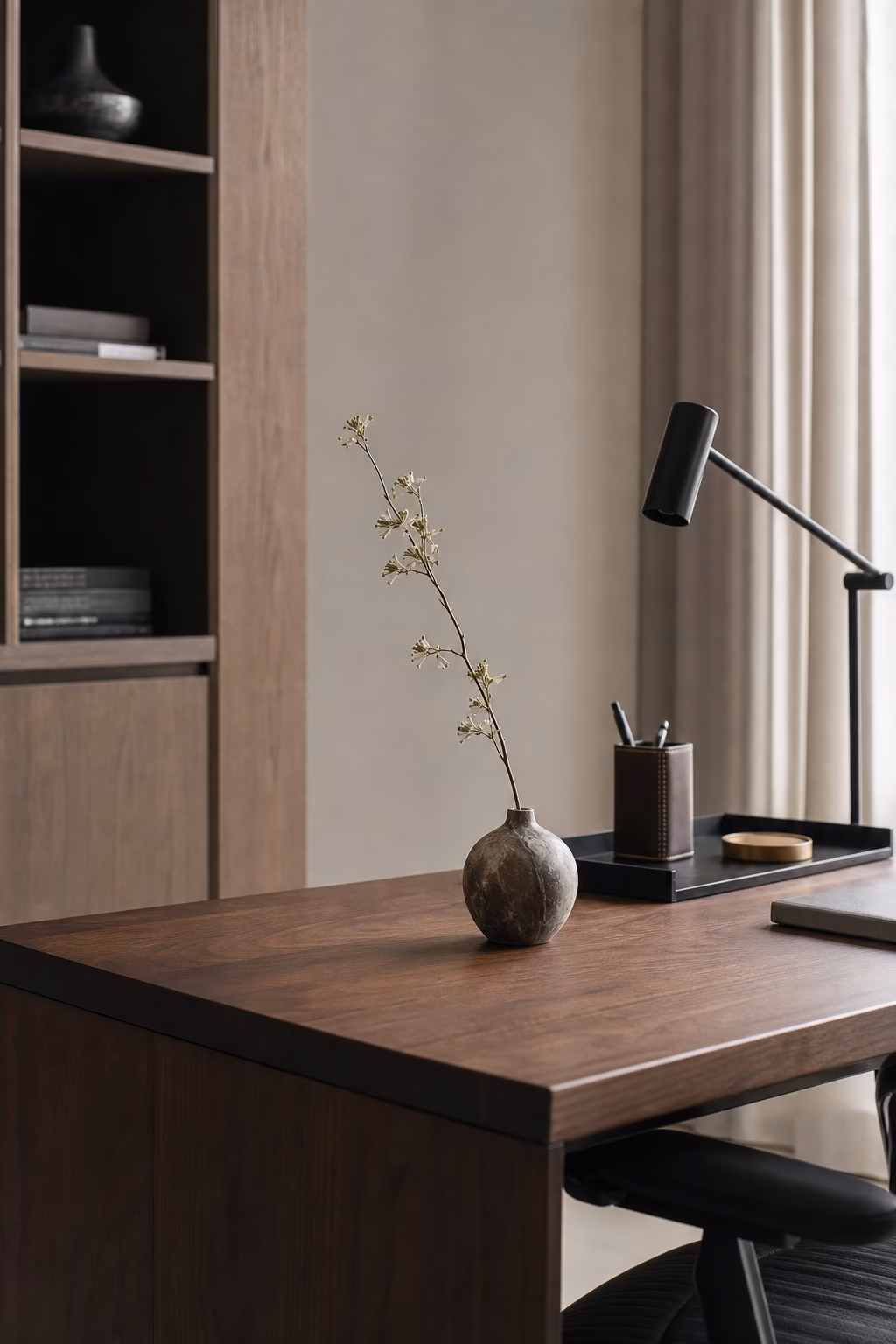 Petite marble vase with a single stem on a home office desk