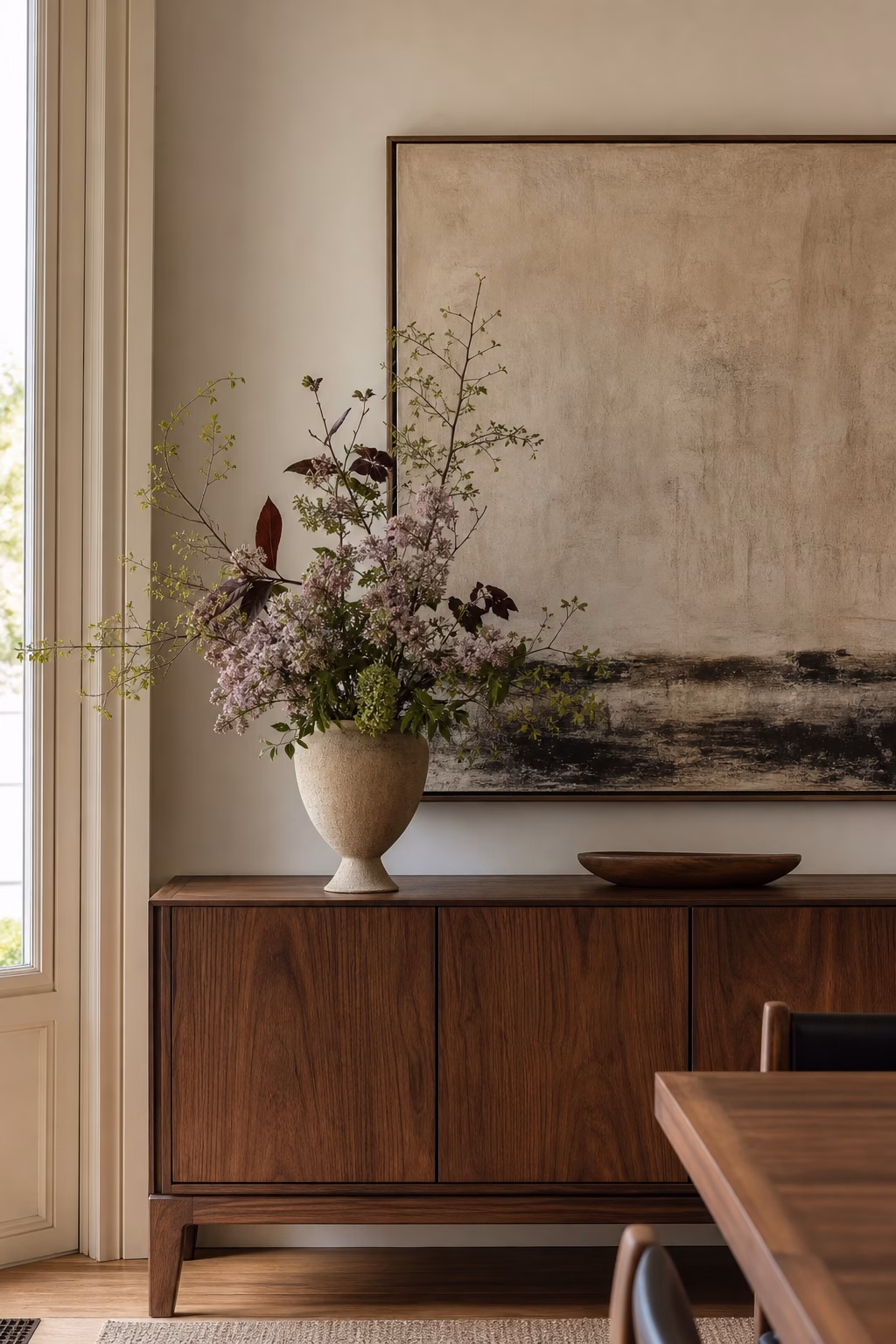 Tall fresh flower vase styled along a dining sideboard