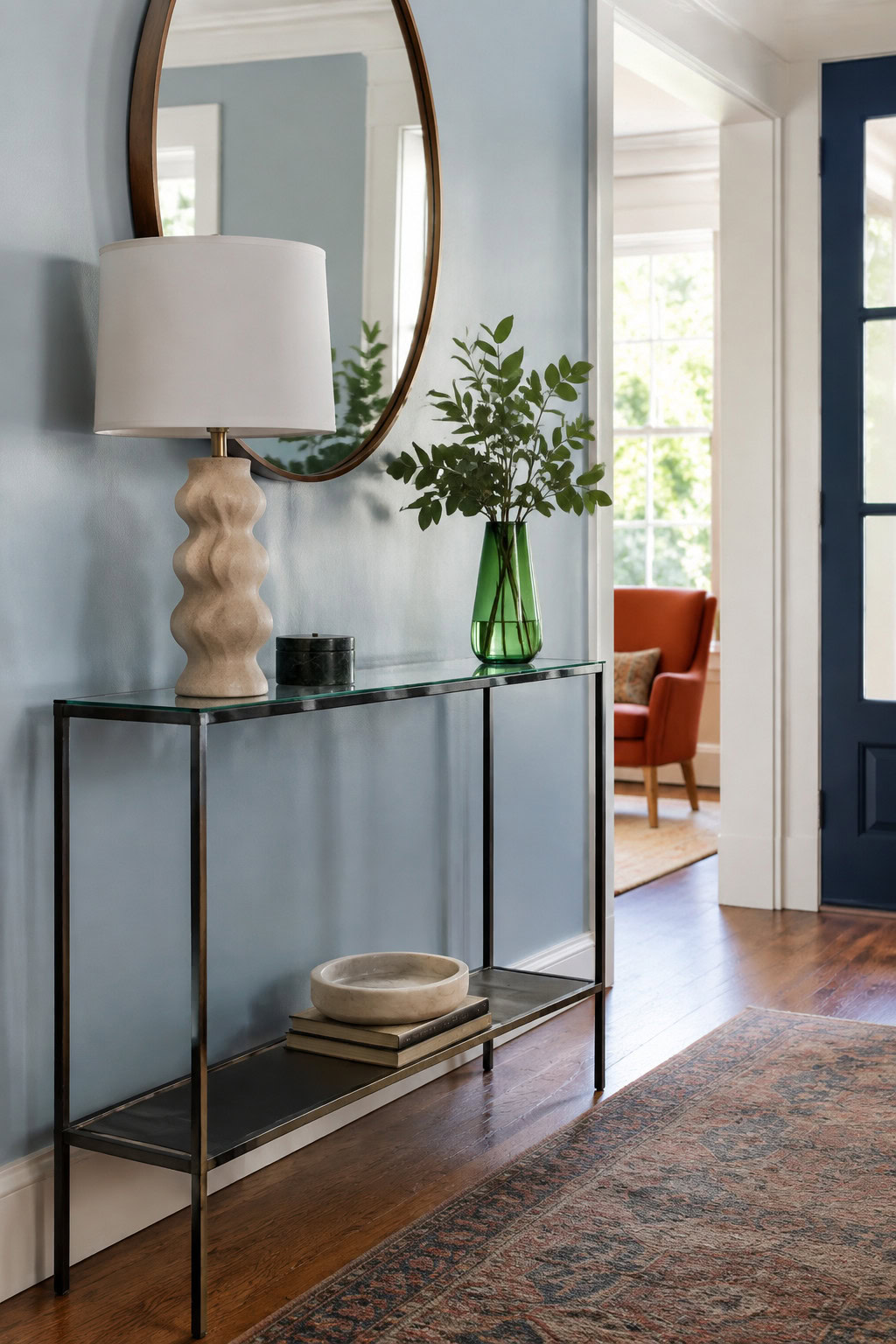 Sleek glass-top console table in a bright entryway