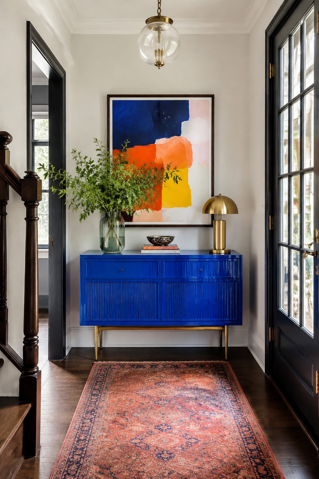 Bold cobalt-blue narrow console in a compact entryway