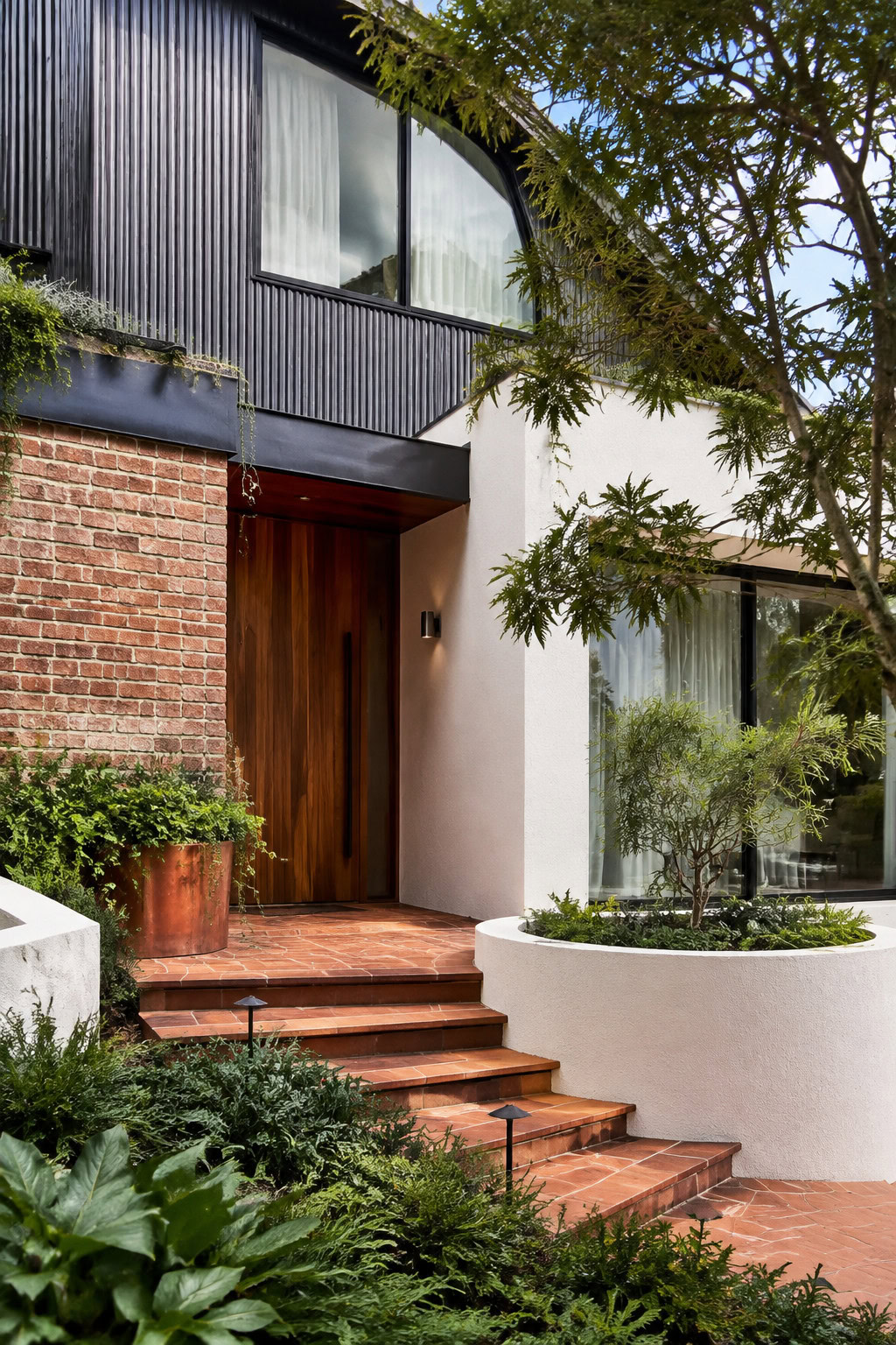Residential facade with brick, fiber-cement, and textured finishes