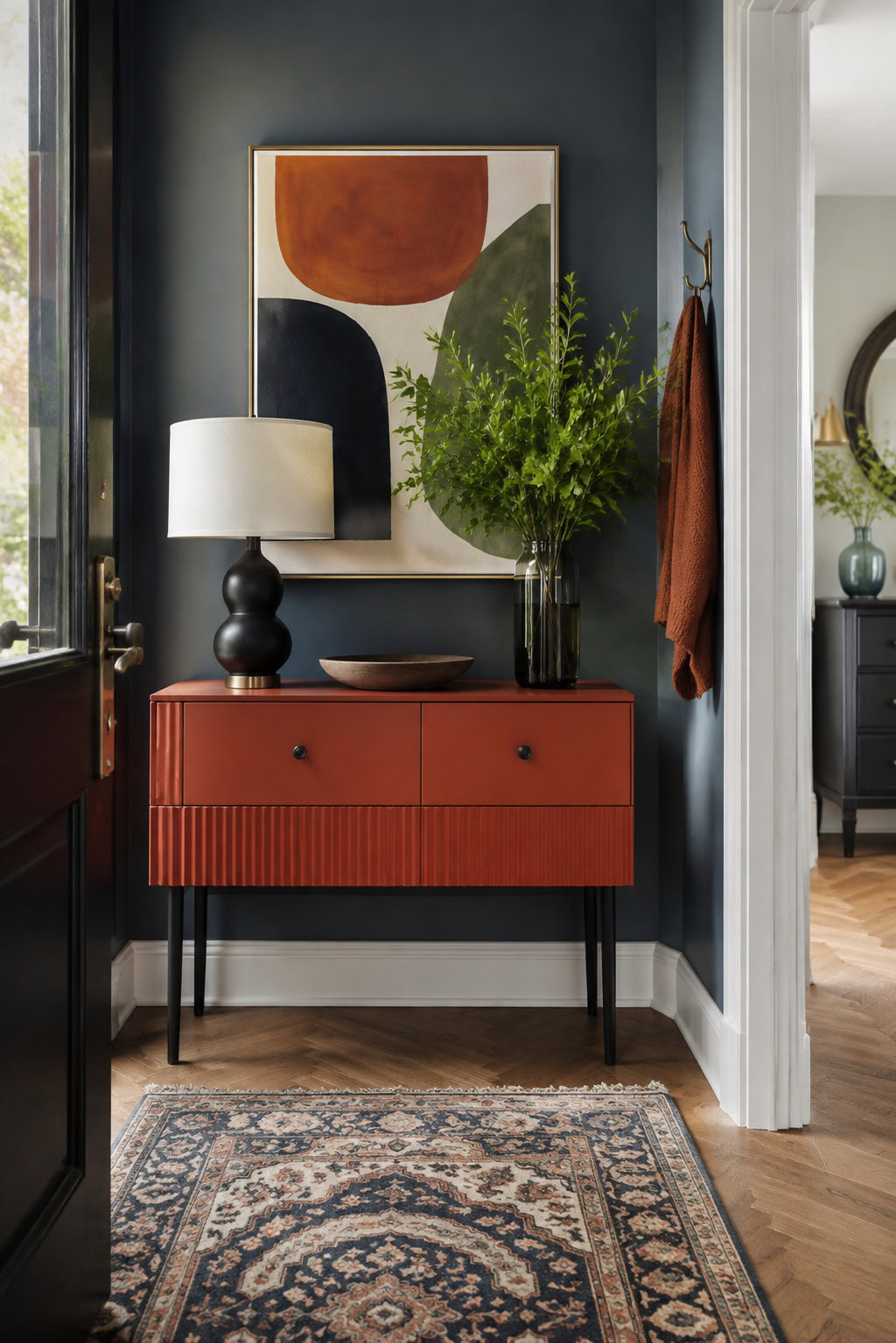 Painted terracotta accent console in a small entryway